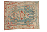 Distressed Vintage Lilihan rug with blue abrashed ground, red medallion, and ivory floral patterns.