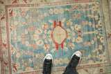 Distressed vintage Lilihan rug, abrashed sky blue field, cherry red floral, arabesque border.