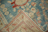 Distressed vintage Persian Lilihan rug corner, showing worn sky blue pile and woven foundation.