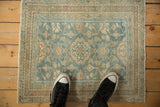 Distressed vintage Hamadan rug in powder blue and ivory, showing floral motifs and worn texture.