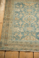Distressed pile and powder blue floral border on the vintage Hamadan rug.