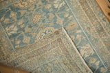 Distressed vintage Hamadan rug pile with powder blue and sand floral vines, showing its woven foundation.