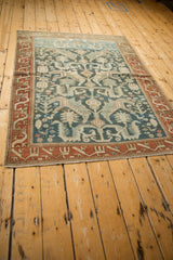Long view of a vintage distressed Mehreban rug showing its full Caucasian-inspired pattern.