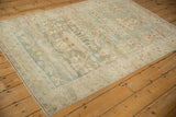 Distressed Hamadan rug corner, dusty blue field, ivory border, and intact selvage.