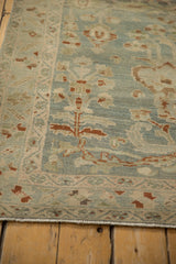 Distressed texture and time-softened hues of the vintage Hamadan rug's floral design.