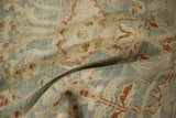 Softly worn texture of a distressed Hamadan rug in muted blue, brown, and ivory.