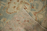 Distressed vintage Hamadan rug's worn dusty blue pile, folded to show hand-knotted foundation.