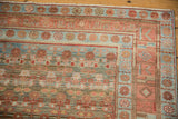 Soft powder blue and raspberry red tones on the worn, low pile of a vintage Kurdish rug corner.