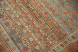 Close-up view of the heavy abrashes and worn, low-pile texture on a vintage Kurdish rug.