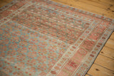 Angled detail of a vintage Kurdish rug highlighting heavy abrashes over the lattice pattern.