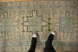 Distressed Karaja runner's geometric pattern, dusty blue, ivory, and charcoal with textural wear.