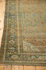Close view of the distressed pile and Turtle Samovar border in dusty blue and terracotta hues.