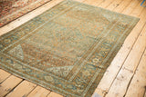 A vintage distressed Bibikabad rug's full pattern in time-softened terracotta and dusty blue.