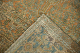 Corner of a distressed Bibikabad rug folded over, showing the hand-knotted back and low pile.