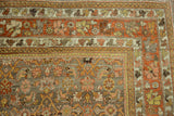 Distressed vintage Bijar rug corner featuring time-softened terracotta, silver, and saffron Herati motifs.