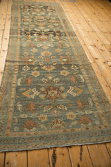 Distressed Lilihan runner detail with terracotta and pale blue floral motifs, even wear.