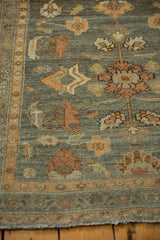 Distressed Lilihan runner's worn end, terracotta border, and floral field detail.