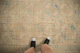 Textured pile of vintage distressed Ersari carpet, cream and dusty teal geometric guls.