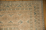 Ersari carpet corner, geometric guls in dusty teal, cream, pale coffee, showing even wear.
