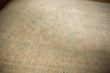Multi-tiered borders and snowflake gul motifs of the distressed vintage Ersari rug, cream and dusty teal.