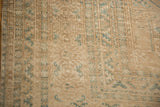 Textural distressed pile of vintage Ersari carpet featuring dusty teal geometric guls.