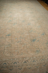Distressed vintage Ersari carpet close-up, showing even wear on ivory, dusty teal snowflake guls.