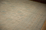 Distressed vintage Ersari carpet, cream field with dusty teal geometric guls, and faint foundation showing.