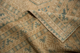 Distressed texture of a vintage Ersari carpet, showing geometric guls and machine-bound side.