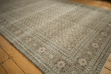 Distressed vintage Tabriz carpet corner, highlighting muted Herati motifs and time-softened pile.