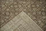 Hand-knotted foundation and distressed Herati pattern of a vintage Tabriz rug in muted tones.