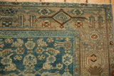 Distressed Kurdish Hamadan rug corner, with floral blue field meeting a stylized Samovar border.