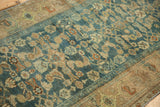 Distressed pile texture of the dusty sapphire blue field with Herati floral motifs.