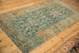 Distressed Kurdish Hamadan rug border detail, camel and ivory meandering vine, dusty blue field.
