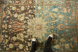 Dramatic color transformation from rich charcoal to dusty blue on a distressed vintage Hamadan rug.