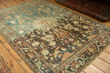 Angled view of a distressed Hamadan rug highlighting its heavily abrashed color variation.