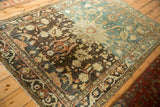Dramatic color abrasion from charcoal brown to dusty sapphire blue on a distressed vintage Hamadan rug.