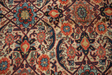 Scrolled leaves, madder red florals, and sapphire blue vinery pattern on an antique Joshegan rug.