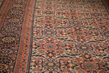 Antique Joshegan Persian carpet shows intricate scrolled leaves, vibrant floral motifs, and unique pawn border.