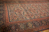 Antique Persian Joshegan carpet corner with madder root red main border and reciprocating pawn motif.
