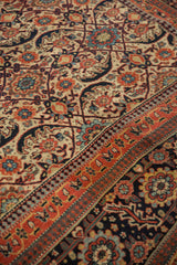 Traditional Joshegan carpet: main border with oversized florals and pawn motif in madder red.