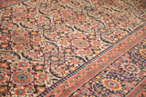 Antique Joshegan carpet border with reciprocating pawn motif and richly colored floral field.