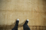 Detail of the distressed low pile and soft beige abrashes on a vintage Kars rug.