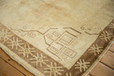 Corner view of a vintage Kars carpet with geometric spandrels and a snowflake border.