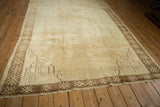 Perspective view of a distressed Kars rug's open field, framed by geometric corner spandrels.
