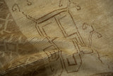 Close-up of a distressed Kars carpet, highlighting the hand-knotted texture and neutral coffee brown pattern.
