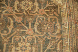 Distressed Mahal carpet close-up: Herati field, geometric Samovar border, muted tones, worn pile.