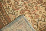 Distressed Mahal rug corner revealing its hand-knotted foundation, intact selvage, and soft-hued pile.