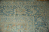 Distressed Mahal carpet corner with abrashed blue, beige floral motifs and visible wear.