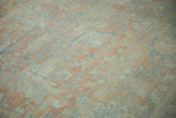 Distressed texture of a Vintage Mahal rug with faded dusty blush and denim blue palmettes.