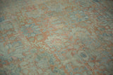 Heavily abrashed vintage Mahal carpet texture with softened floral motifs in faded blush and dusty blue.